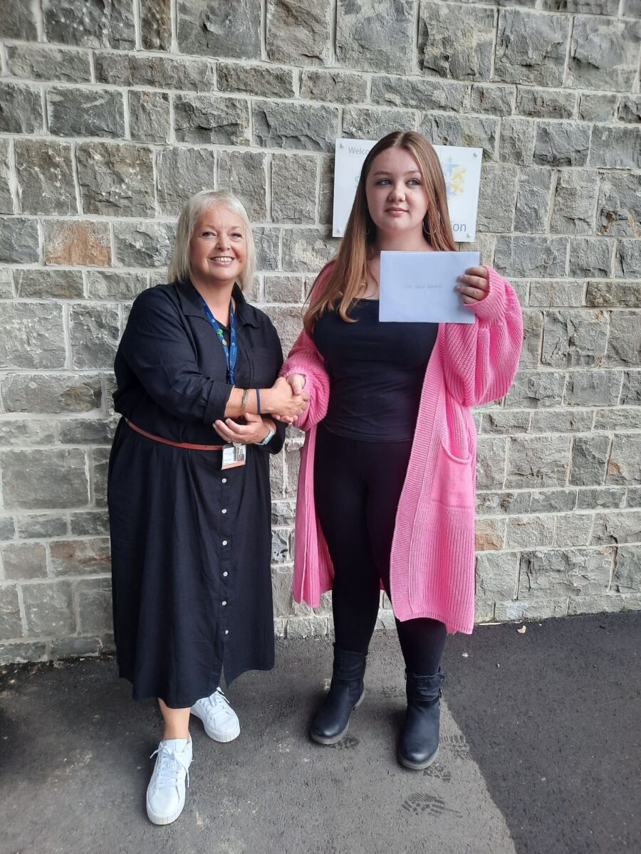 Student holding their results with Dee Pickerill, Principal of Leigh Academy Snowfields.