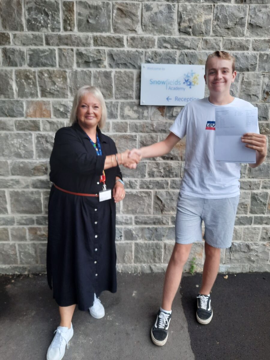 Student holding their results with Dee Pickerill, Principal of Leigh Academy Snowfields.