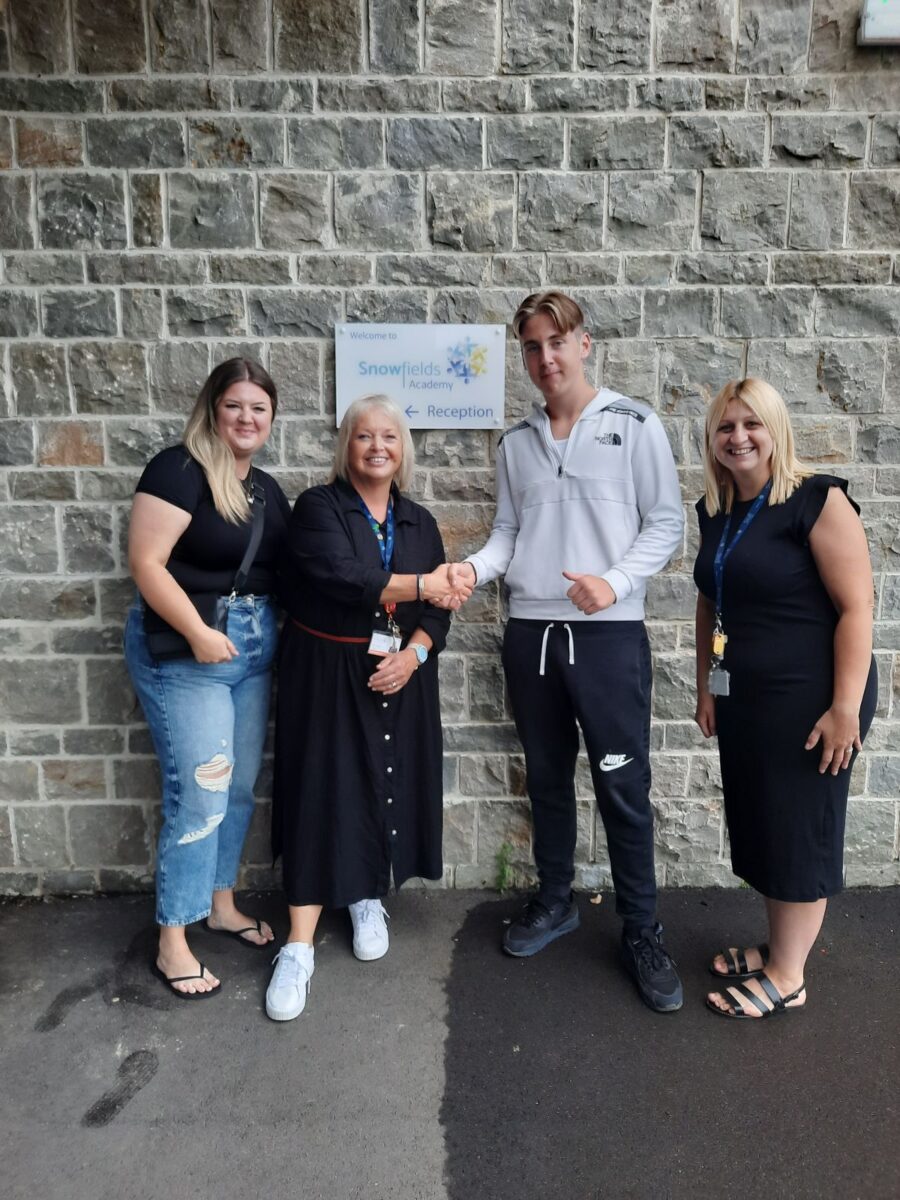 Student holding their results with their family and Dee Pickerill, Principal of Leigh Academy Snowfields.