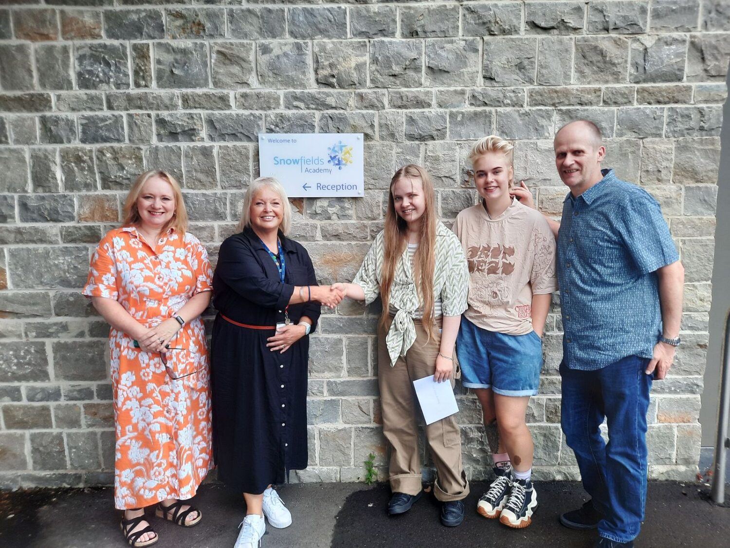 Student holding their results with their family and Dee Pickerill, Principal of Leigh Academy Snowfields.