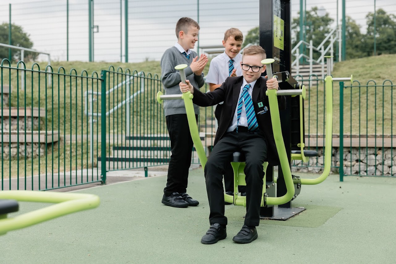 Students playing on outdoor exercise equipment
